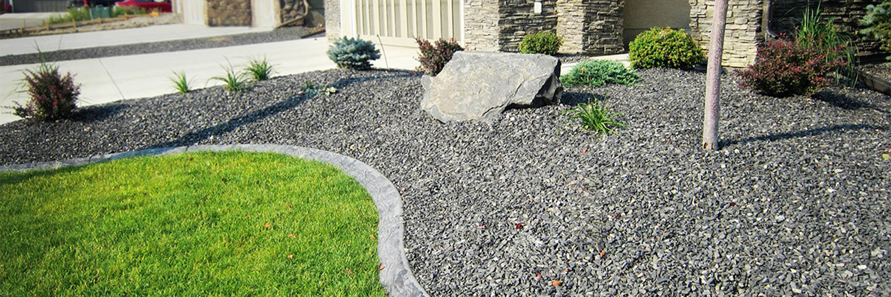 Bulk landscape supply materials including decorative rock and soil at Calgary yard