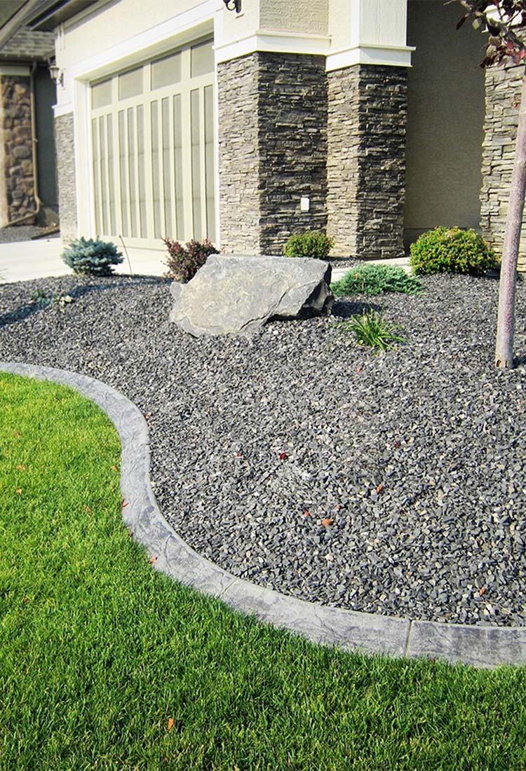Bulk landscape supply materials including decorative rock and soil at Calgary yard