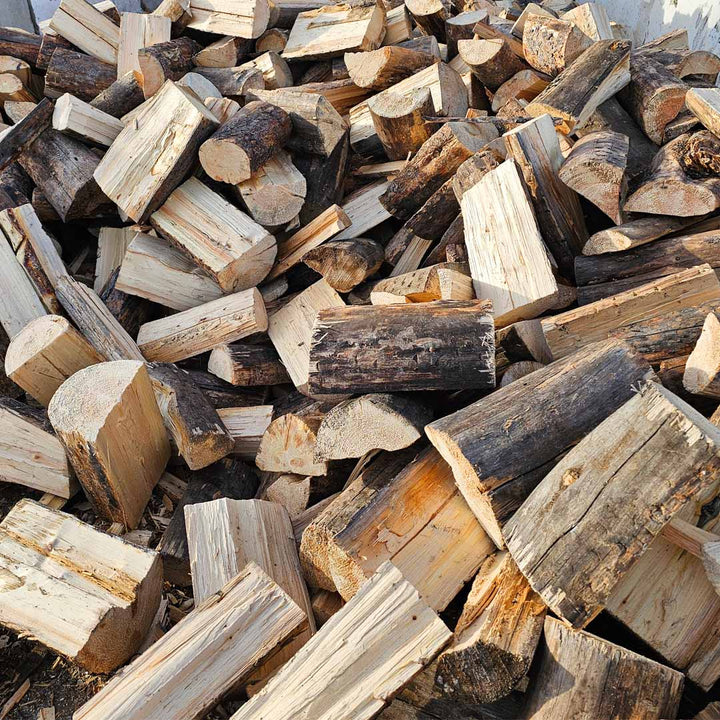 Pine firewood in bulk bag available in Calgary from TMH Industries, sold in 1/4 cord size for easy handling, fast burning, and clean fires for indoor or outdoor use.