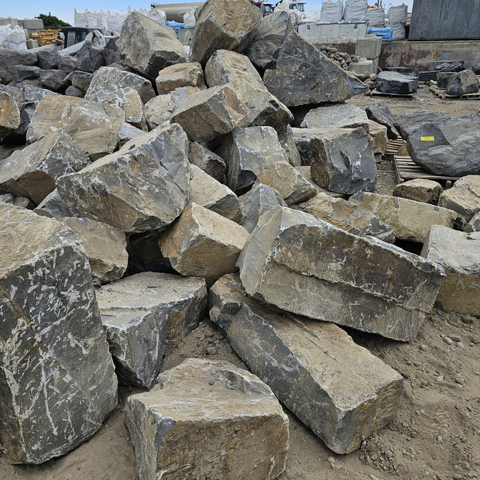 Stackable landscape boulders for Calgary homeowners and contractors, ideal for garden walls, natural edging, and outdoor landscaping projects.