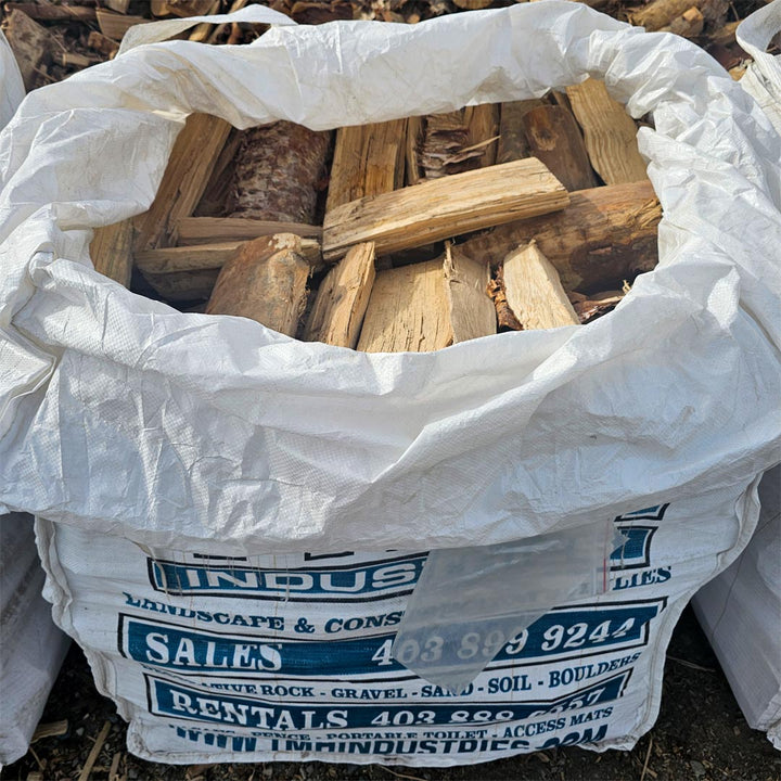 Birch firewood quarter bag, clean premium hardwood ideal for fireplaces, camping, and backyard fire pits from TMH Industries Calgary.